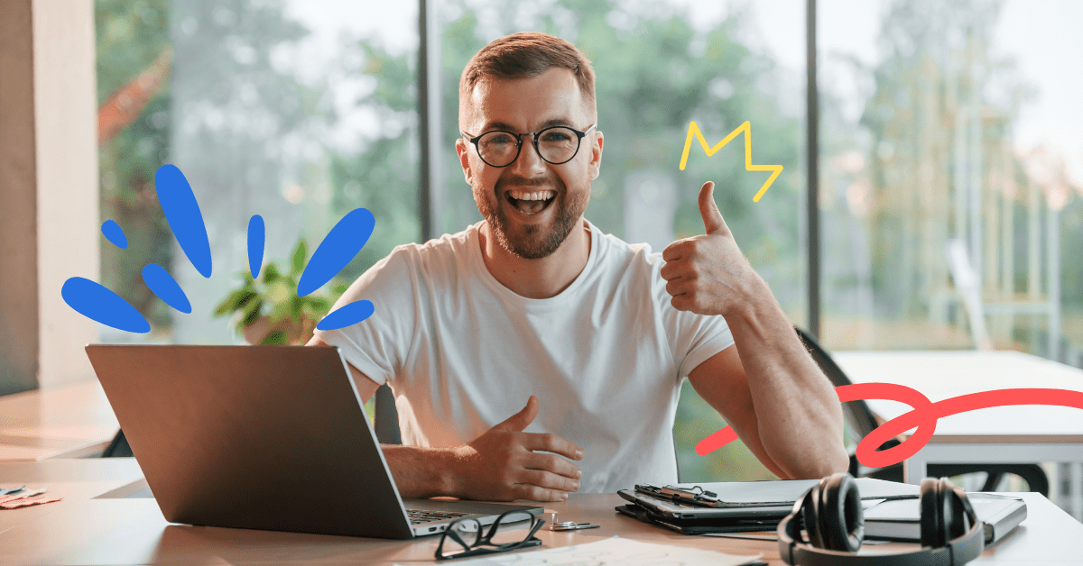 A guy looking happy in a white t-shirt making a thumbs-up sign