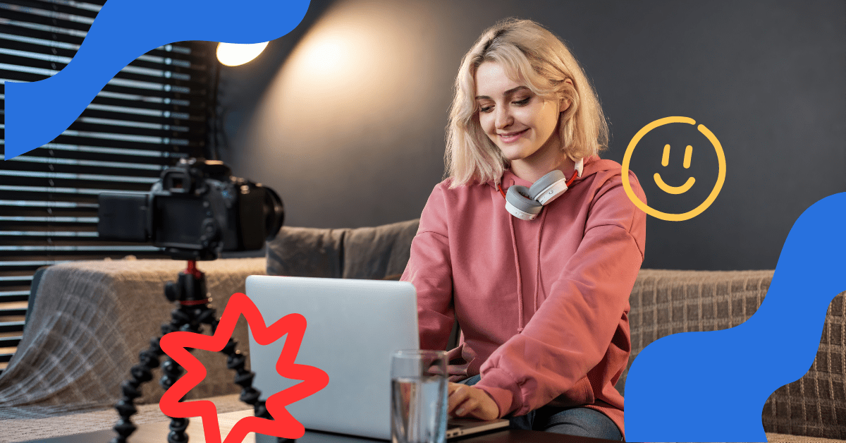 A woman in a pink sweater editing youtube video on a laptop