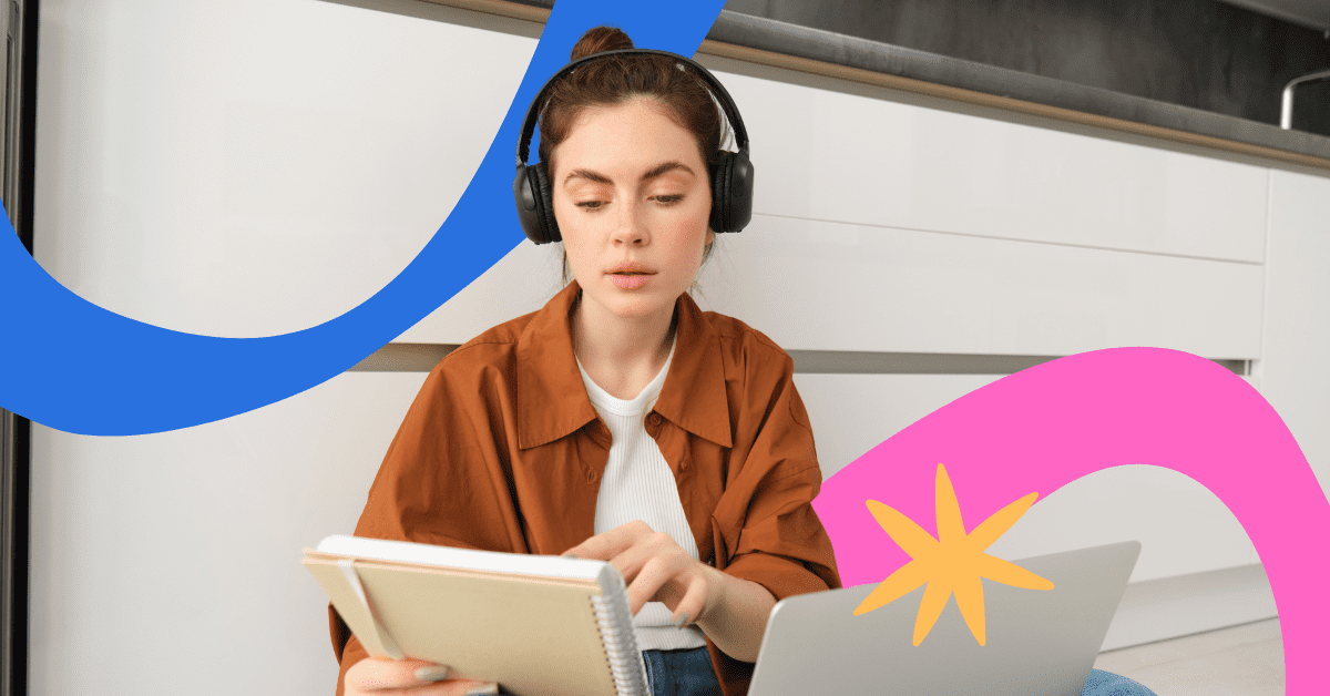 A woman wearing headphones and a brown shirt working infront of a laptop